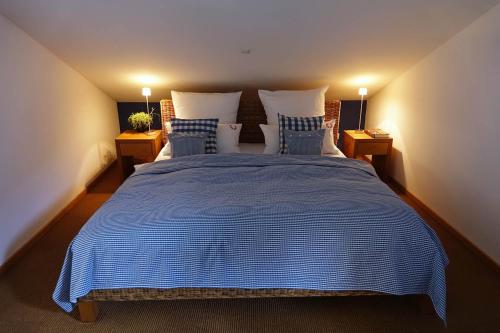 a bedroom with a large bed with blue sheets and pillows at Schittlerhaus in Oberstdorf