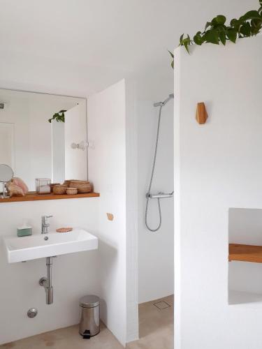 a bathroom with a sink and a mirror at Casa da Bica d'Água in Óbidos