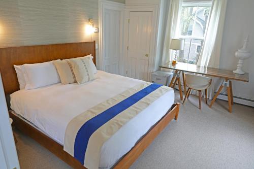 A bed or beds in a room at The Hotel Marblehead