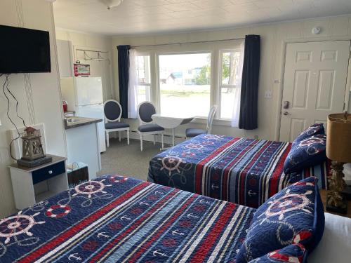 sypialnia z 2 łóżkami i kuchnia z oknem w obiekcie Pure Paradise Resort w mieście Carp Lake