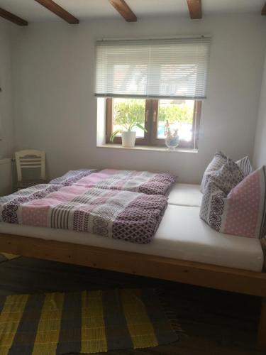 a bed sitting in a room with a window at FeWo Jestetten in Jestetten