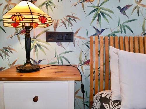 a lamp on a table next to a bed at Privat Hotel Liberty Sitges in Sitges
