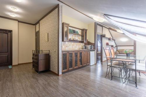 a living room with a table and a dining room at Hotel Pechory-Park in Pechory