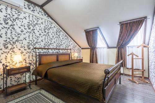 מיטה או מיטות בחדר ב-Hotel Pechory-Park