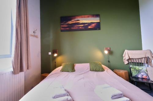 a bedroom with a white bed with at Maison d'Hôtes Cerf'titude in Érezée