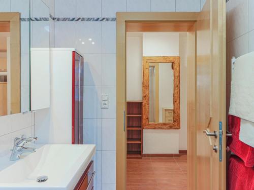 a bathroom with a sink and a mirror at Koglbauer - Apartment Nr 3 in Söll