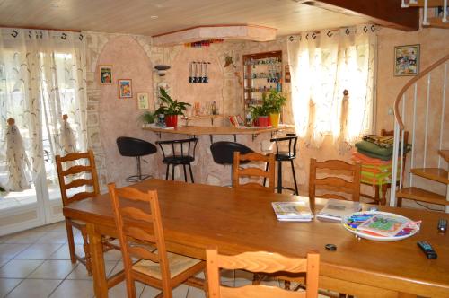 a dining room with a wooden table and chairs at chambre AU DOUX REFUGE in Crans
