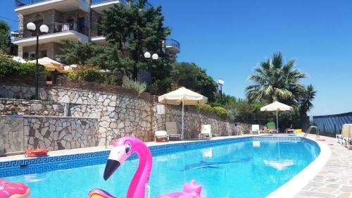 a swimming pool with a pink flamingo in it at Mathia Apartments in Mathía