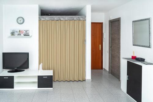 a living room with a television and a sliding door at Lorena in Salou