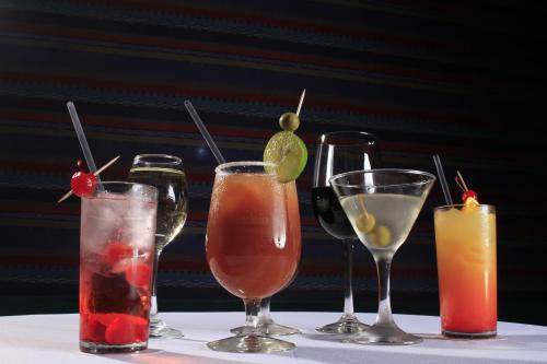a group of four different cocktails on a table at Crowne Plaza Monterrey Aeropuerto by IHG in Monterrey