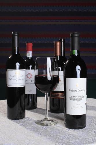 a group of wine bottles and a glass of wine at Crowne Plaza Monterrey Aeropuerto by IHG in Monterrey