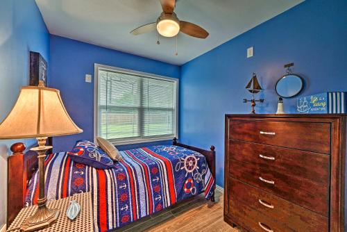a bedroom with a bed and a dresser and a ceiling fan at Less Than 3 Mi to South Padre Beach Port Isabel Home in Port Isabel
