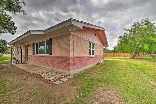 a small red brick house in a yard at Less Than 3 Mi to South Padre Beach Port Isabel Home in Port Isabel