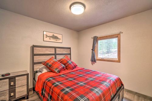 a bedroom with a bed and a window at Cozy Downtown Soldotna Cabin Dogs Welcome! in Soldotna