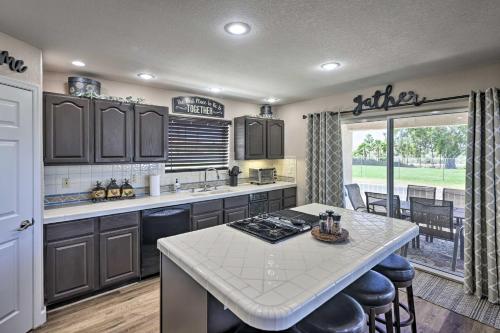 a kitchen with a white counter top and a table at Amenity-Packed Home with Hot Tub and River Views! in Bullhead City