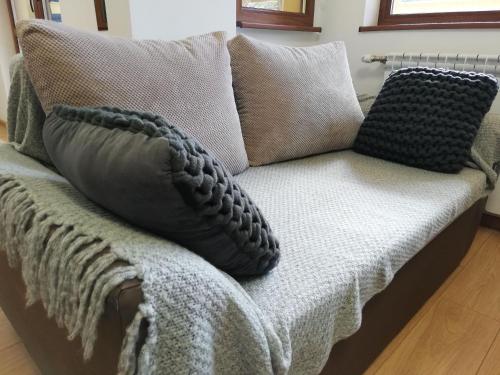 a couch with pillows on top of it at The Yellow House in Stara Zagora