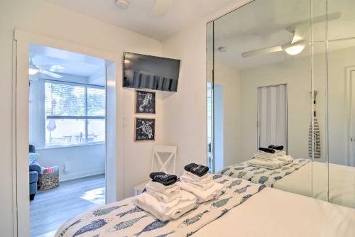a bedroom with two beds and a mirror at Florida Unit Steps from Indian Rocks Beach Access! in Clearwater Beach