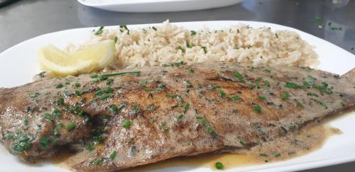 a plate of food with rice and a piece of meat at L'Huitrière in Quiberville