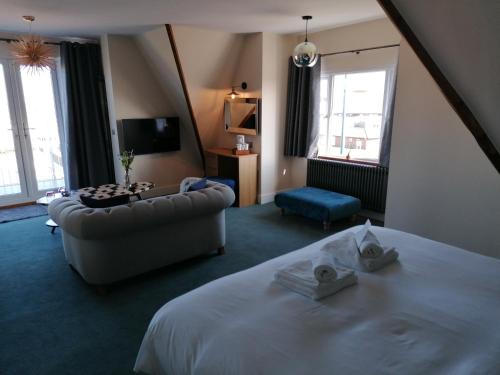 a hotel room with a bed and a couch at Marine Lodge in Great Yarmouth
