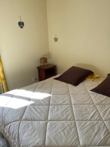 a bedroom with a large white bed in a room at la ferme de Martine in Lent