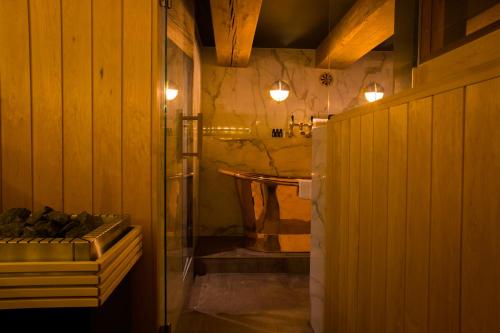 a bathroom with a shower and a tub at Boutique Hotel The Noblemen in Amsterdam