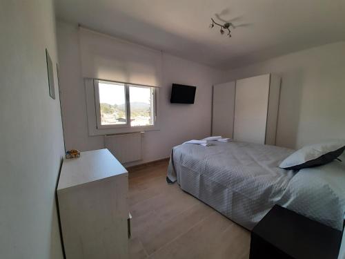 A bed or beds in a room at Ca l'Aren Cardona