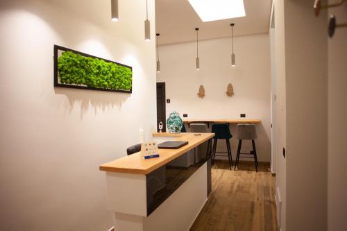 a kitchen with a counter and a tv on the wall at 4heavens_naples in Naples