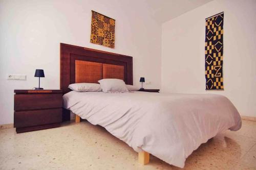 a bedroom with a large bed and two night stands at Casa rural “Ca Robert” in Callosa de Ensarriá