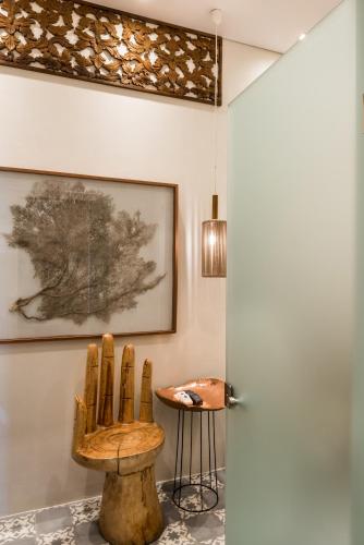 a room with a wooden chair and a table at Nyx Chic Manor in Chania Town