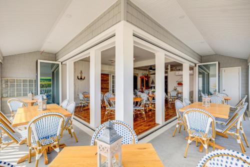 a dining room with tables and chairs on a patio at Surf City Hotel in Surf City