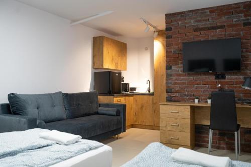 a living room with a couch and a tv at Good Night in Warsaw