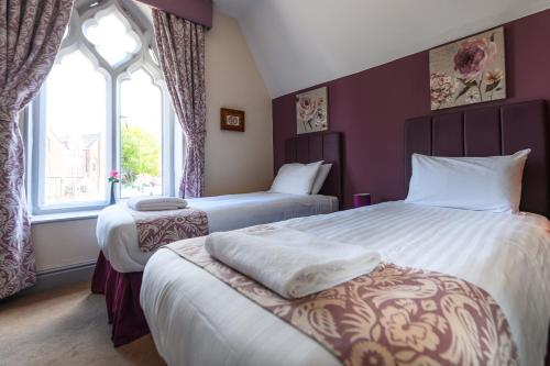 a hotel room with two beds and a window at The Lemon Tree in Wrexham