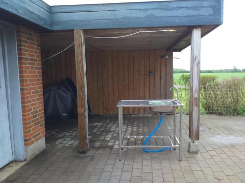 a table under a shed with a blue roof at Villa in Brande in Gammel Blåhøj
