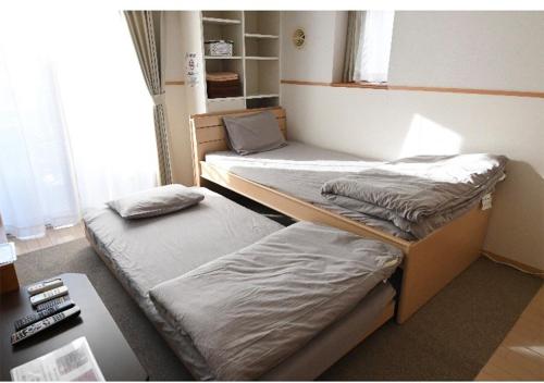 two bunk beds in a room with a desk at Marvelous Kokubunji - Vacation STAY 29877v in Kokubunji