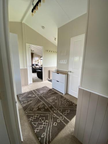 a living room with a black and white rug at Rew Farm Country & Equestrian Accommodation - Sunrise Lodge in Melksham