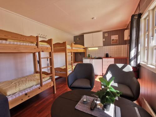a living room with two bunk beds and a table at Reipå Camping in Reipå