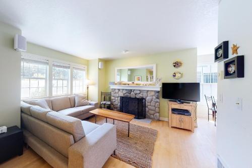 a living room with a couch and a fireplace at Nedonna Beach House in Rockaway Beach