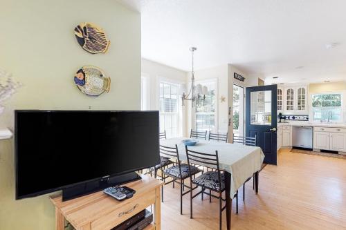 a living room with a large flat screen tv at Nedonna Beach House in Rockaway Beach