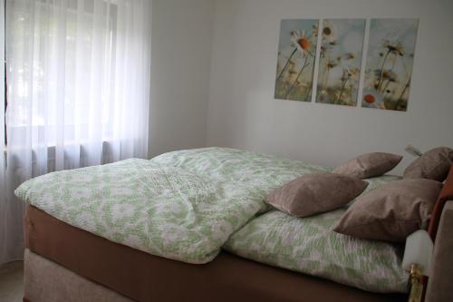 a unmade bed with pillows in a bedroom at Ferienwohnung Waldblick in Schluchsee