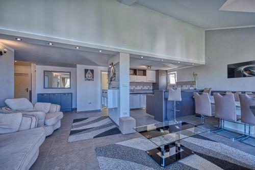 a living room with a couch and a table at Porto View Three-Bedroom Duplex in Tivat
