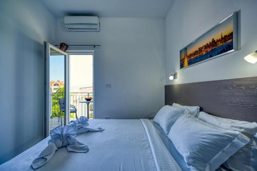a blue bedroom with a bed with a bow on it at Porto View Three-Bedroom Duplex in Tivat