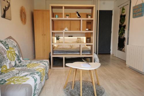 a living room with a couch and a table at Appartement cosy Roscoff 50 m plage thalasso WIFI PARKING in Roscoff