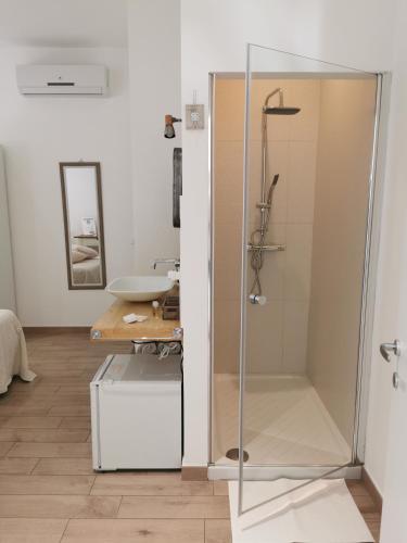 a shower with a glass door in a bathroom at Vento d'aMare in Leporano