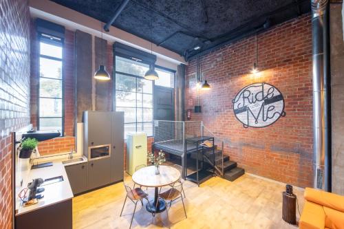 a room with a brick wall with a table and a counter at ART LOFTS Valencia by Benisur in Valencia