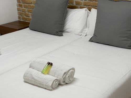 a bed with towels and a ring on top of it at Oktheway Pedro Saco Street in Sarria