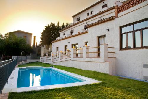 a house with a swimming pool in the yard at La Luna del sur B&B in Granada