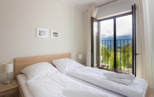Ένα ή περισσότερα κρεβάτια σε δωμάτιο στο Apartament Panorama z widokiem na góry