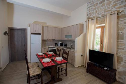 a small kitchen with a table and a television at Iris house Sivas (Ex. Sivas Villa 1) in Sívas