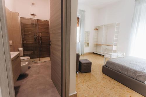 a bedroom with a bed and a bathroom with a shower at THE NEST - Luxury suites in Pescara