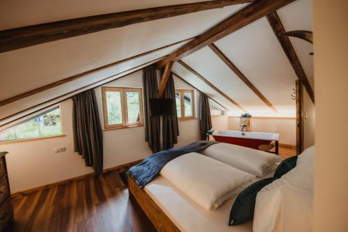 a bedroom with a large bed in a attic at Chalet Passeier - RIVER in Saltusio